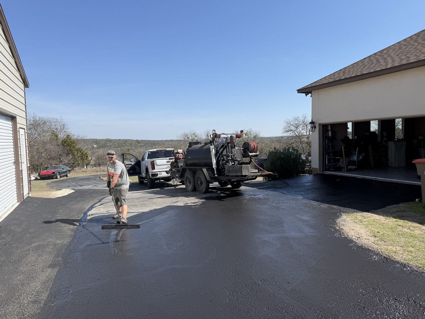 Brooks crew sealcoating an asphalt driveway in the Texas Hill Country